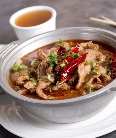 A pork chili curry with chopsticks.