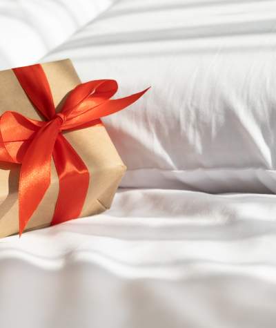 Gift on bed - Shutterstock