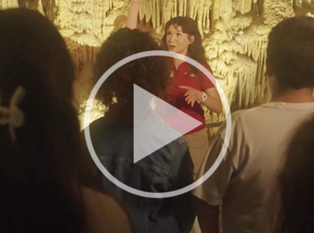 Tour guide with class inside cave
