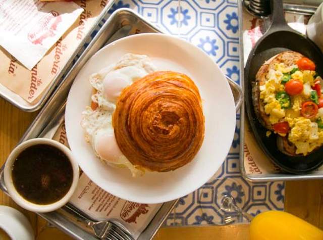 Overhead view of croissant sandwich and coffee