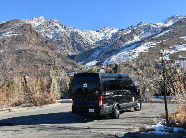 Ski shuttle with snow covered mountains in the background