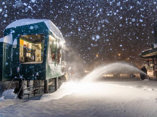 Guy snow blowing with snow falling at an Alta lift