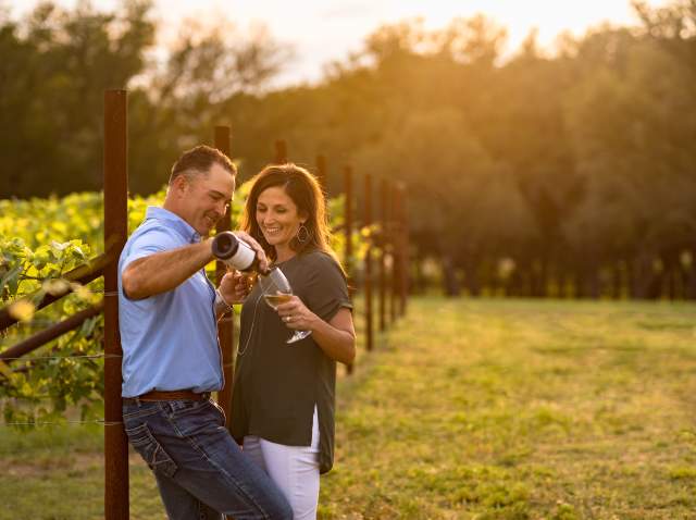 Man and woman enjoying wine at Signor Vineyards in Fredericksburg
