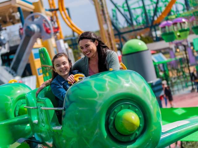 Mother and daughter smiling on Green Lantern ride at Six Flags Fiesta Texas.