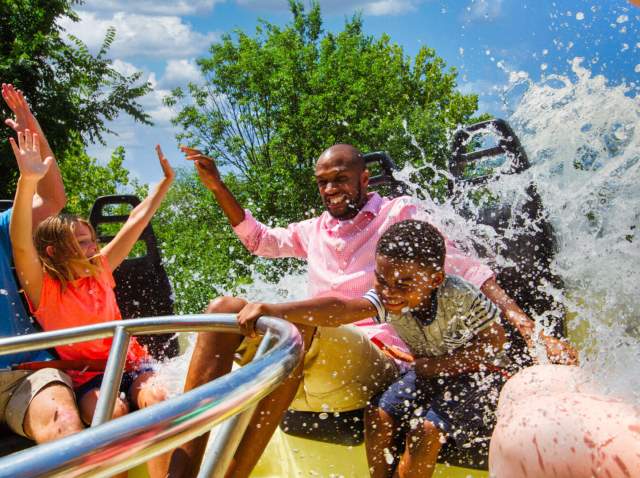 Family on circular ride being splashed