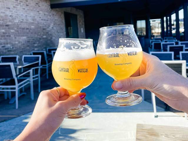 Central Waters beers outside cheersing