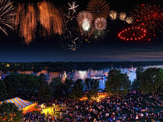 downtown fireworks over river during festival