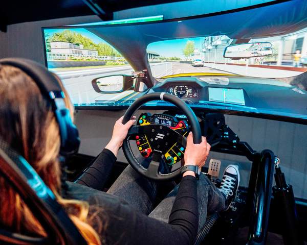 A picture showing a person in a race simulator
