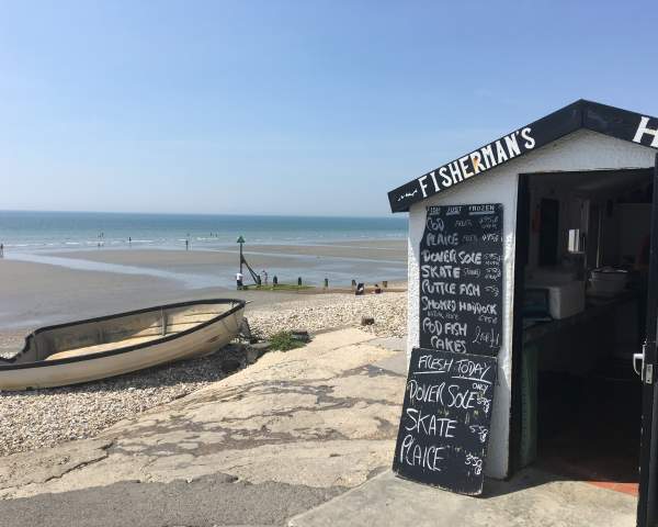 a view of east wittering beach with seafood hut