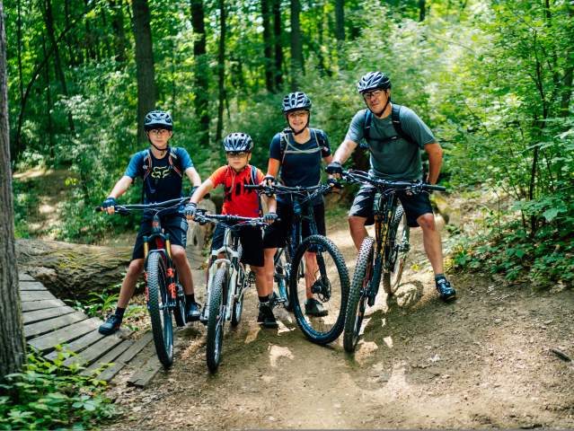 Family of four on mountain bikes on DTE Energy Foundation Trail