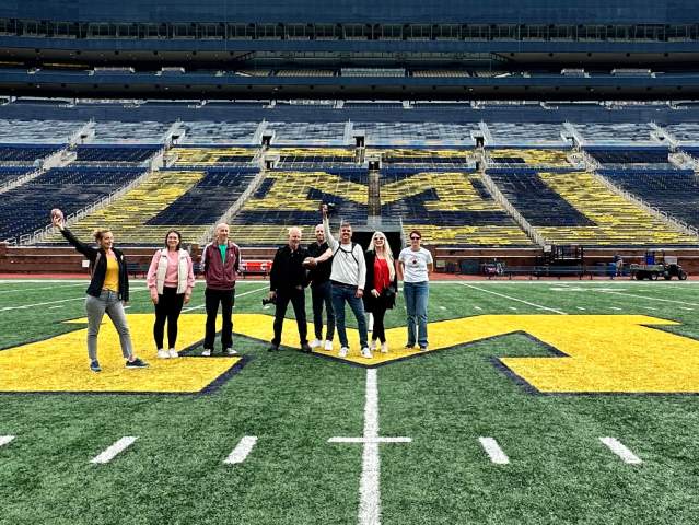 Tour group standing on field of Michigan Stadium