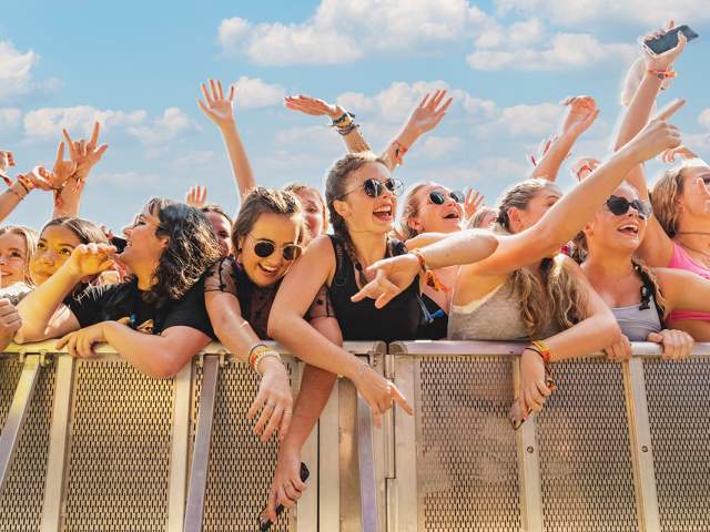 Crowd of young women against the festival barricade in front of stage at ACL Music Festival