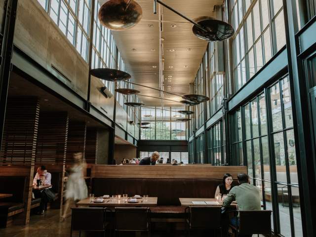 Image of the interior of Comedor with people dining at the tables.