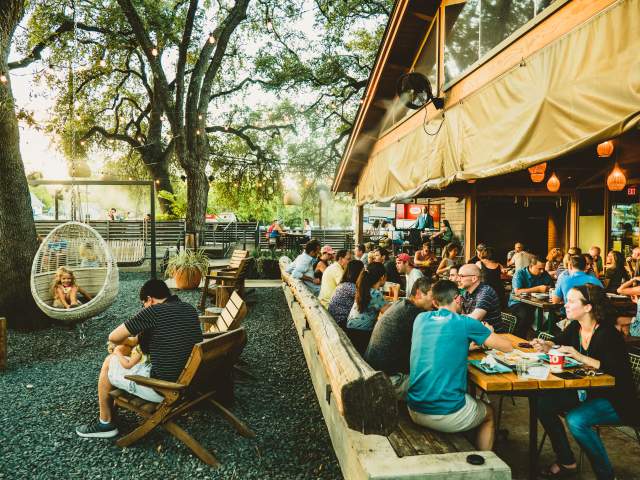people dining on the patio at Loro in austin texas