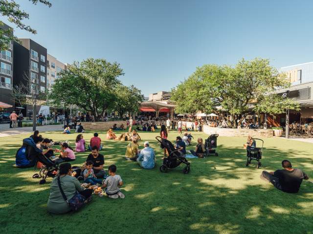 people picnicking on the Northside Lawn at the Domain NORTHSIDE shopping area