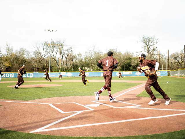 Baseball players in action during a game at Downs Field