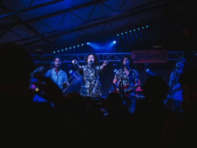 Superfonicos on stage at the Mohawk lead singer points out towards the crowd