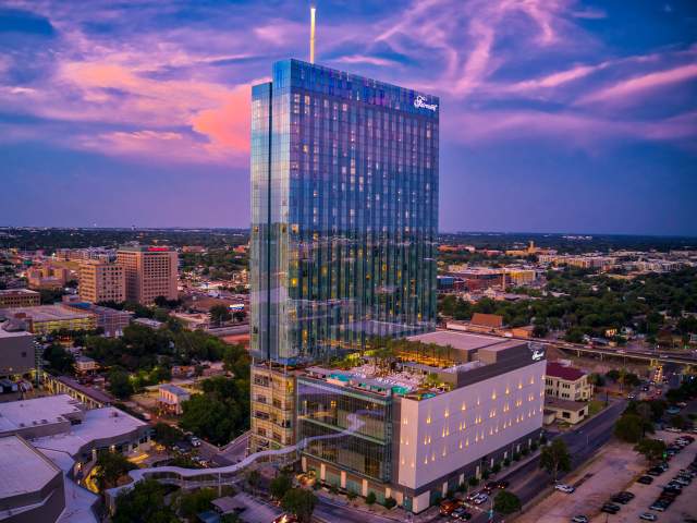 Exterior at sunset with skybridge and rooftop pool at the Fairmont hotel in Austin Texas