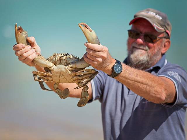Man holding a mud crab caught at Pardoo Station in the Pilbara
