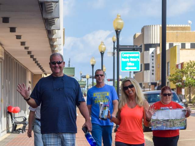 A group of people enjoying touring the geocaching attractions in downtown Beaumont.