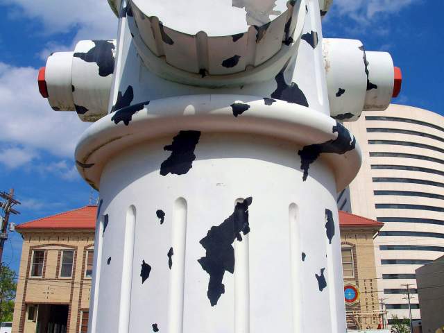 Girl sitting in front of the Giant Fire Hydrant in Beaumont