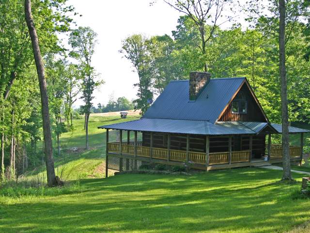 Exterior view of a cabin with a wrap around porch