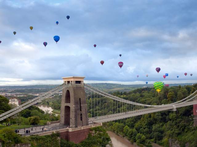 Balloons flying over the Clifton Suspension Bridge in West Bristol during one of the morning mass ascents from the Bristol Balloon Fiesta - credit Gary Newman