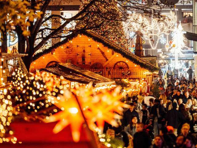 Christmas lights and stalls with Cabot in background - Credit James Bridle