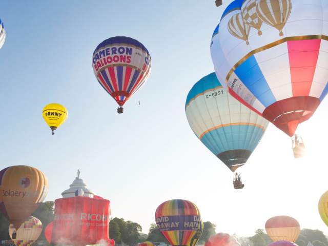 A group of balloons lifting off in a mass ascent at Bristol International Balloon Fiesta - credit Paul Box