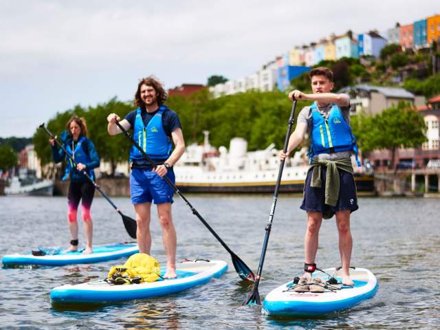 Group on paddelboards in Bristol harbour - credit SUP Bristol