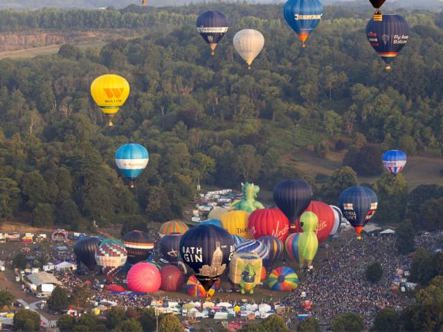 Balloons lifting off in a mass ascent at Bristol International Balloon Fiesta 2025
