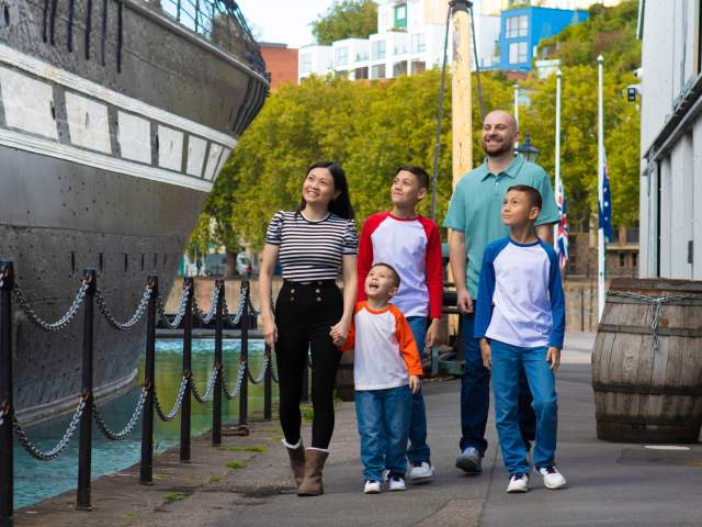 A family exploring the exterior of the SS Great Britain in the Great Western Dockyard, Bristol - credit Brunel's SS Great Britain