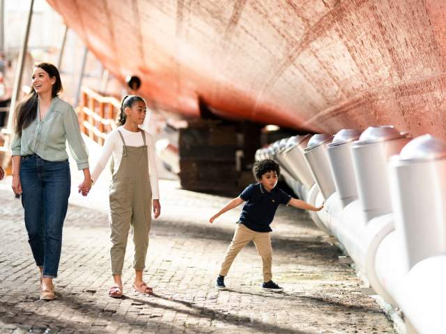 A family exploring the dry dock at Brunel's SS Great Britain, Bristol - credit Brunel's SS Great Britain