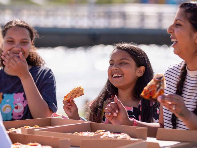 A family eating pizza at The Wave inland surfing lake near Bristol - credit The Wave