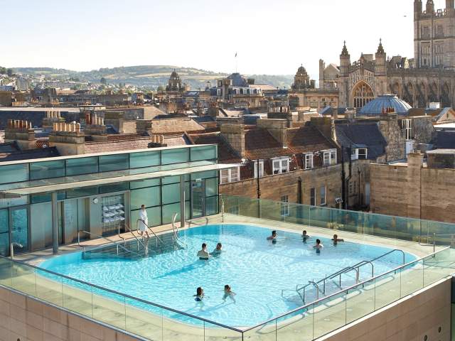 An aerial view of the rooftop pool at the Thermae Bath Spa in central Bath near Bristol, with Bath's skyline in the background
