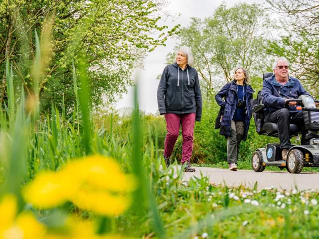 A mobility scooter user on a trail with family at WWT Slimbridge Wetland Centre near Bristol - credit WWT Slimbridge Wetland Centre