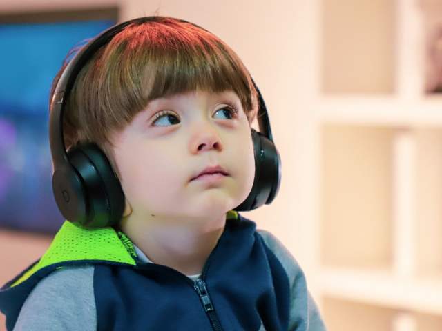 A young boy wearing headphones at the We The Curious science centre in Bristol - credit We The Curious
