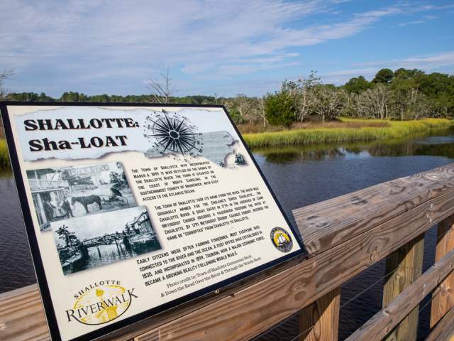 informational board on a wooden railing