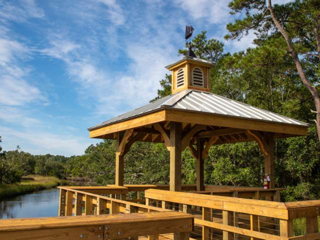 wooden gazebo and walkway overlooking a river