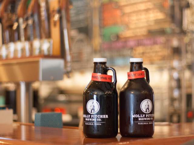 Growlers sitting on the bar at Molly Pitcher Brewing Co in Carlisle
