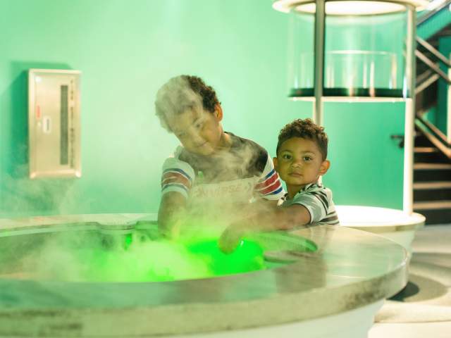 Two boys enjoying science center exhibit