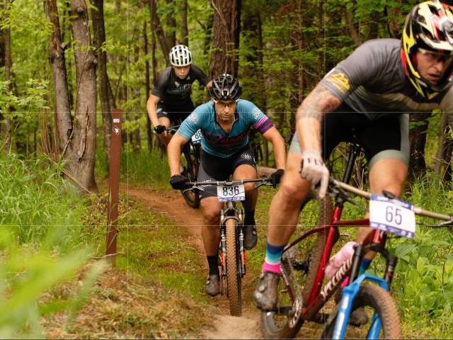 Three men mountain biking