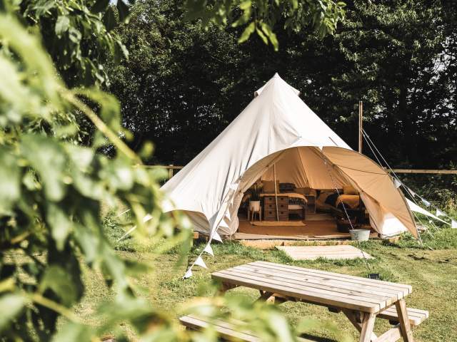 A bell tent amongst the greenery of Little Otchan Glamping in East Yorkshire