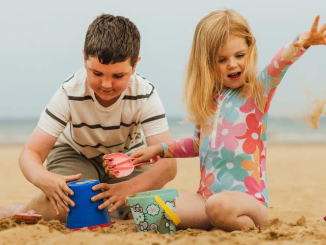 Two children building sandcastles on Bridlington's south beach