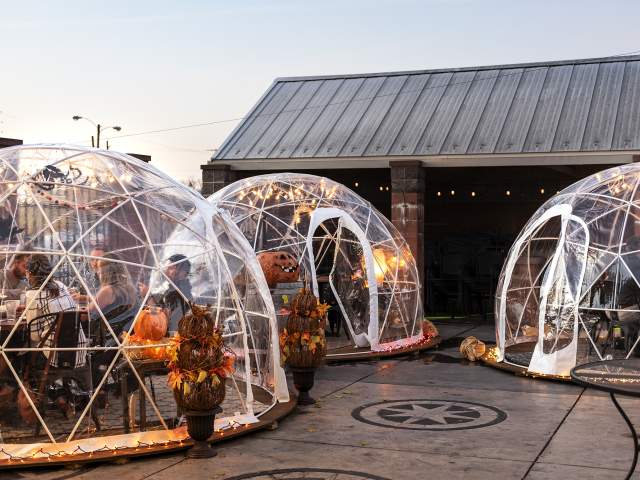 Igloos provide heated outdoor fall dining on the patio at Three Rivers Distillery