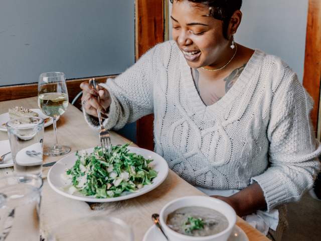 Woman eating at Junk Ditch Brewing Company