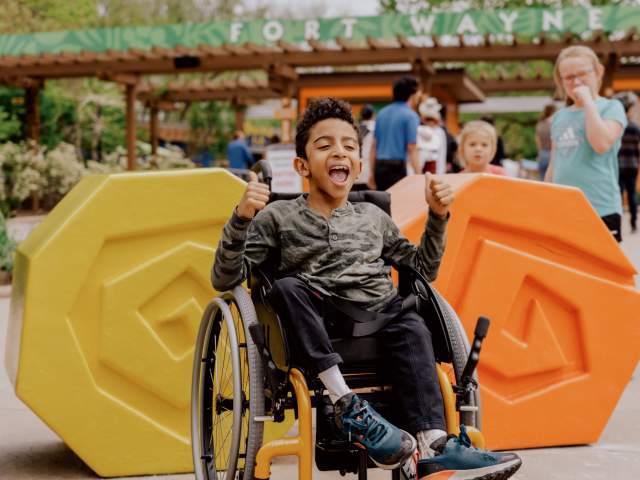 Boy in wheelchair enjoying the zoo