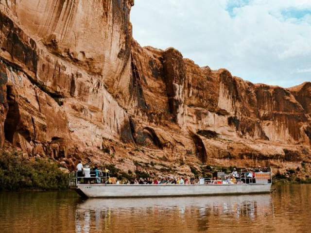 Passengers embarking on a Floating Concert boat down the Colorado River, a signature event hosted by the Moab Music Festival.