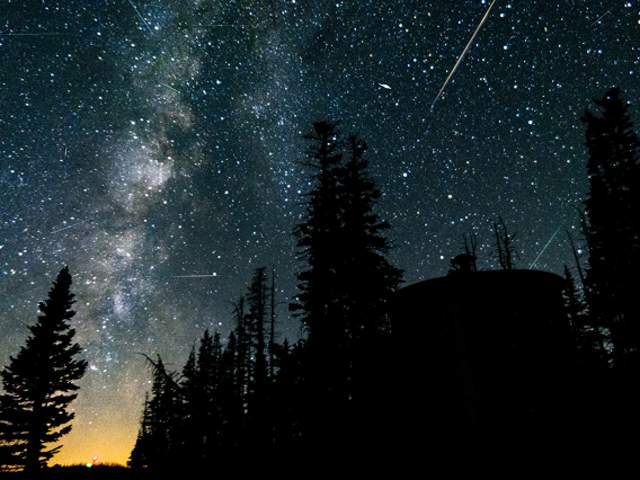 Radiant streaks of the Perseid meteor shower and the vibrant band of the Milky Way.