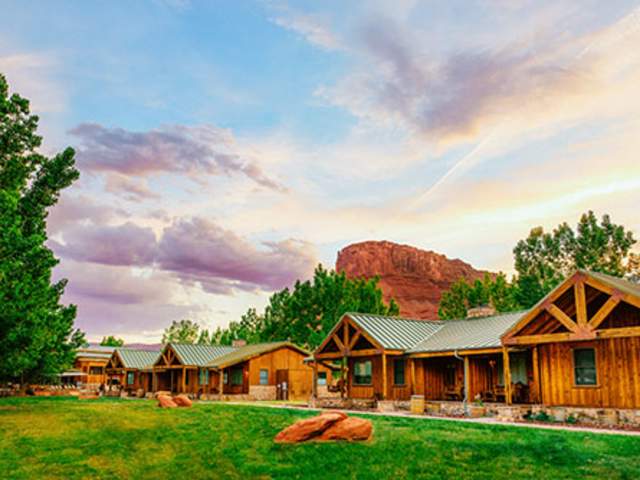 Cabins in Moab, Utah, surrounded by red rocks.
